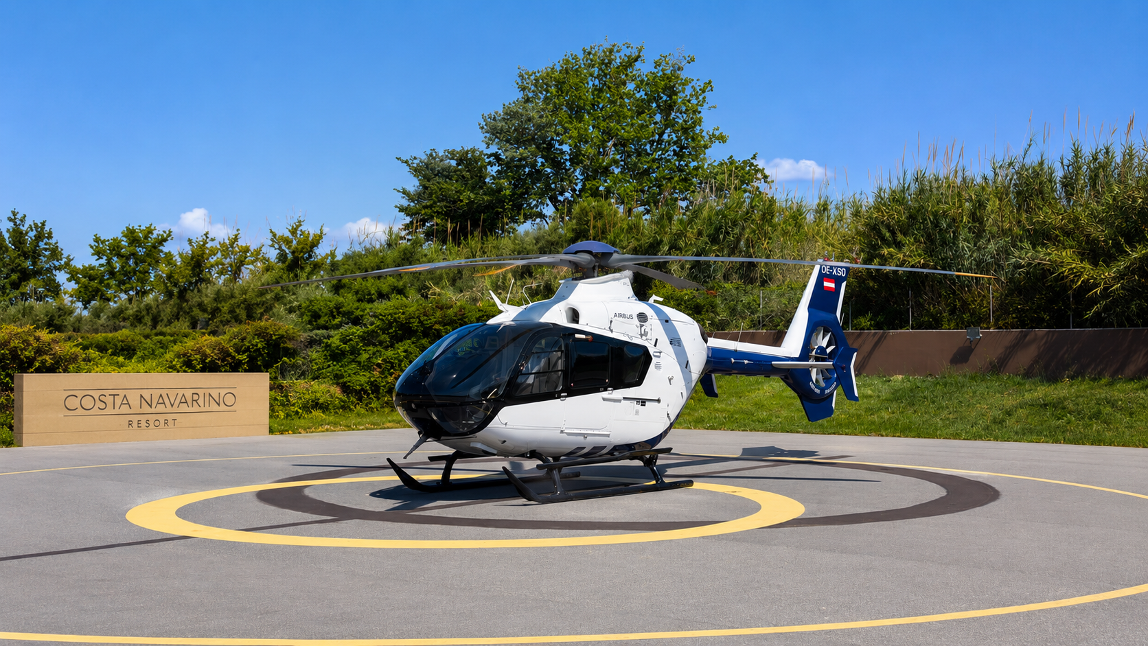 Airbus H135 helicopter at Costa Navarino Resort helipad during a private luxury transfer in Greece