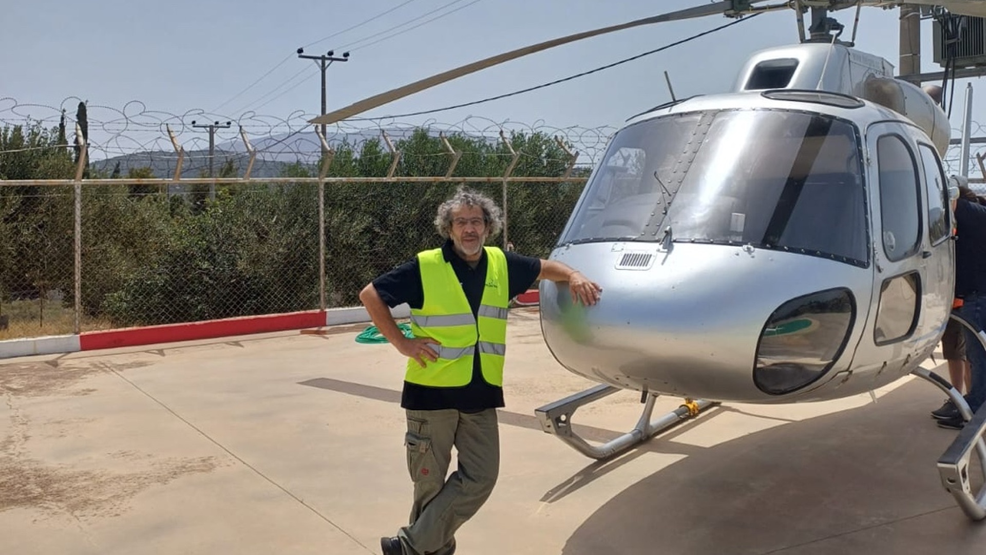 Nikos Ladas ground support coordinator assisting helicopter operations on Greek island helipad for Fly G Aviation